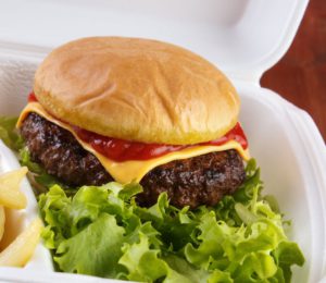 *** Local Caption *** Burger and fries portion in takeout food box